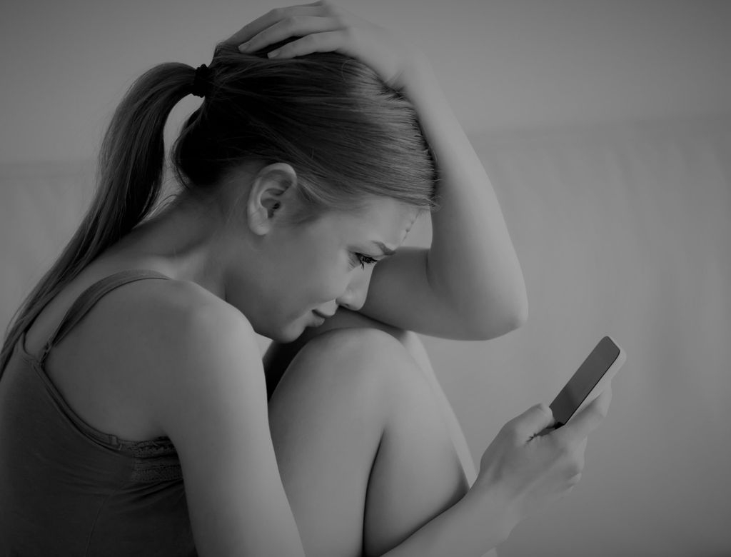 Woman Crying While Reading Message On Cellphone 1 Scaled(1)