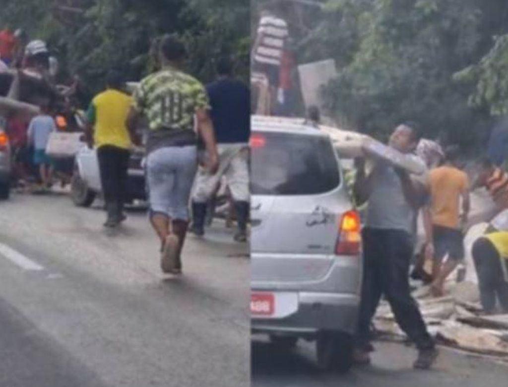 Carreta com móveis tomba e população saqueia carga; Veja vídeo!