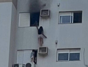 Mulher pendurada em ar-condicionado (Foto: Reprodução)